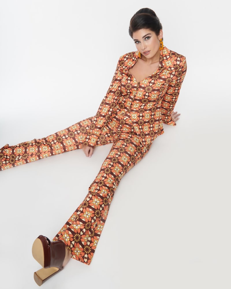 Side of a model wearing a size L Unique Vintage Orange & Brown Mosaic Flare Pants in Orange, Brown by Unique Vintage. | dia_product_style_image_id:300779